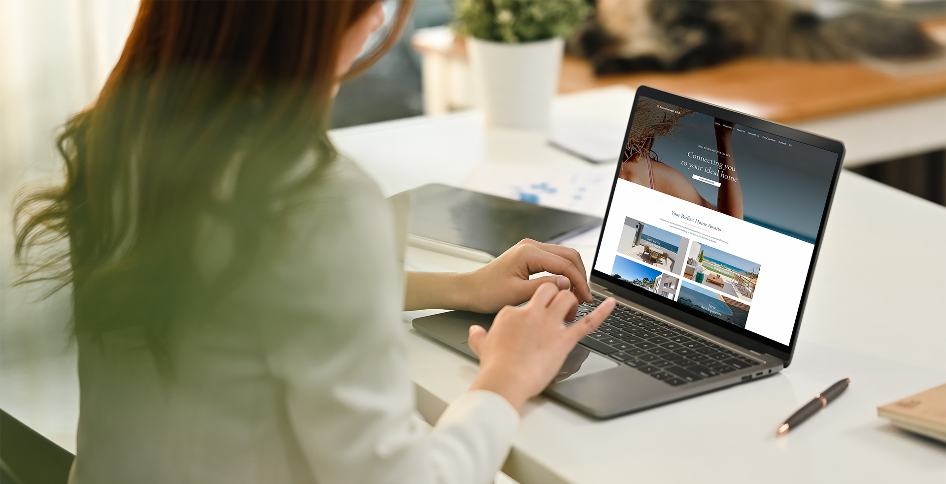 Side view of female manager sitting at her workplace and watching online presentation on laptop computer.